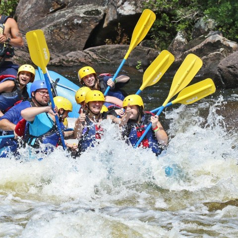 a group of people on a raft in the water